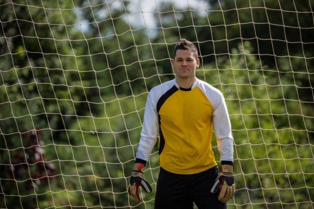 istock Goalkeeper standing near goal post 872966820