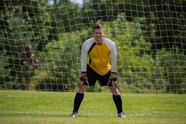 istock Goalkeeper standing near goal post 872968566