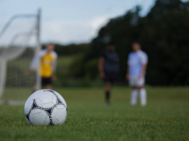 istock Soccer ball on green grass 872969266