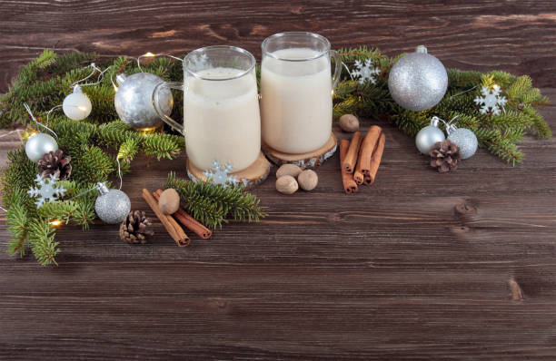 istock Christmas drink eggnog with nutmeg, cinnamon, Christmas tree, pine cones, on a wooden background 872969800