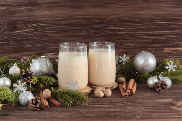istock Christmas drink eggnog with nutmeg, cinnamon, Christmas tree, pine cones, on a wooden background 872969830
