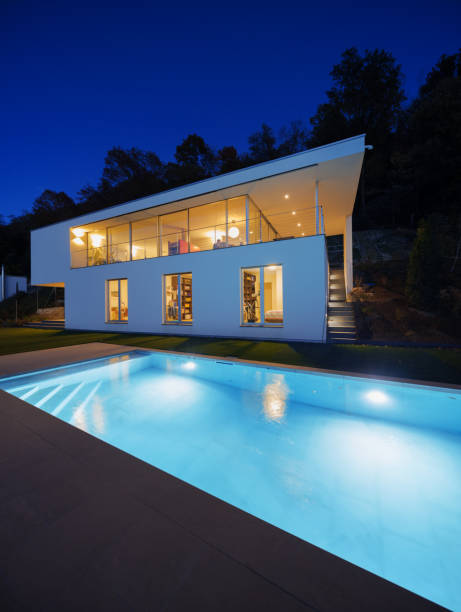 istock Modern villa, exterior in the night, lights on 872972702