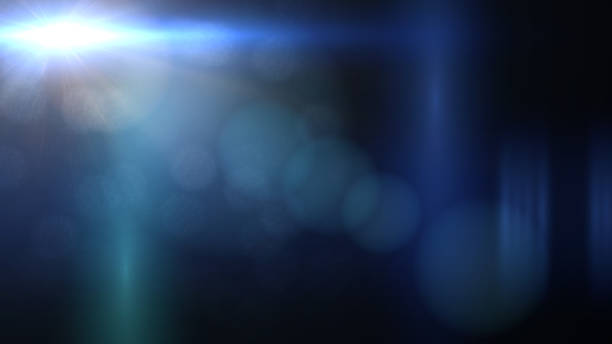 istock bright blue lens flare effect on black background, overlay texture with light streaks 872973690