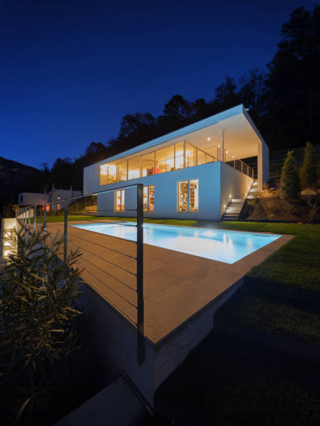 istock Modern villa, exterior in the night, lights on 872976028