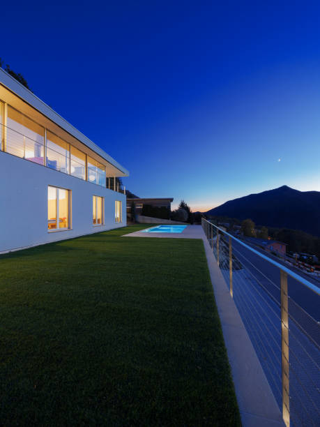 istock Modern villa, exterior in the night, lights on 872976660