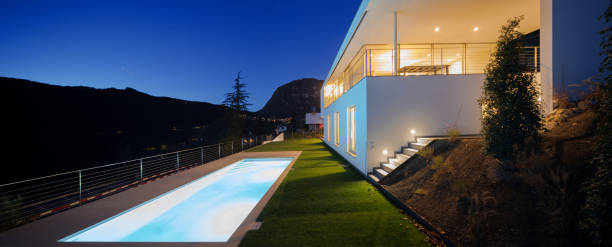istock Modern villa, exterior in the night, lights on 872979124