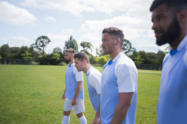 istock Football players standing in ready position 872979248