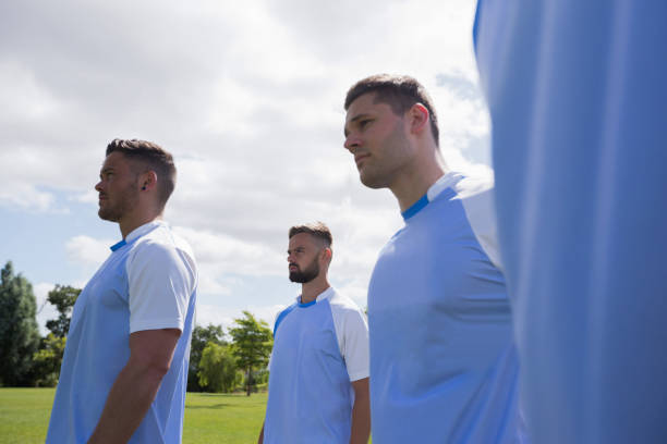 istock Football players standing in ready position 872979354