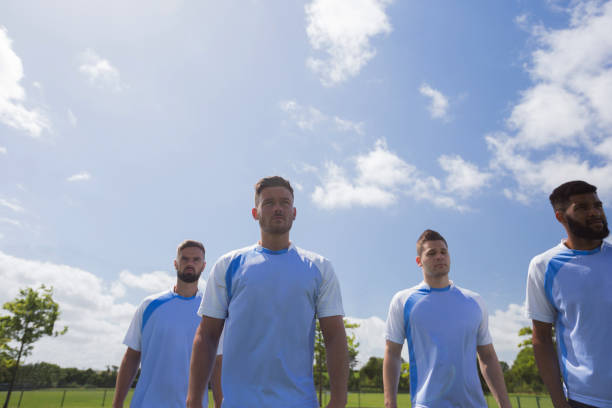 istock Football players standing in ready position 872979380