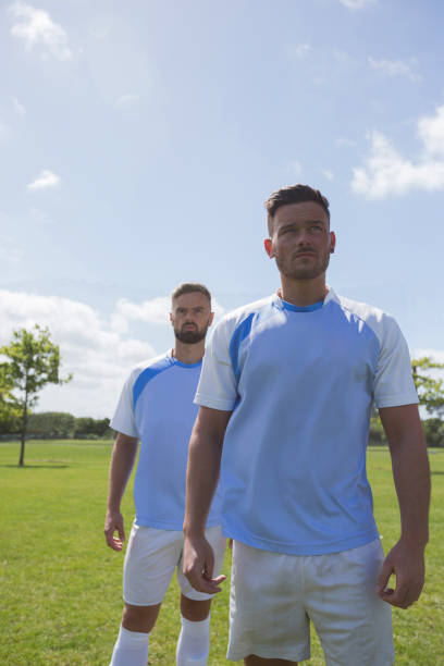 istock Football players standing in ready position 872979442