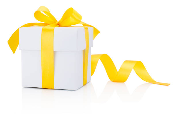 istock White gift box tied yellow ribbon bow Isolated on white background 872979648