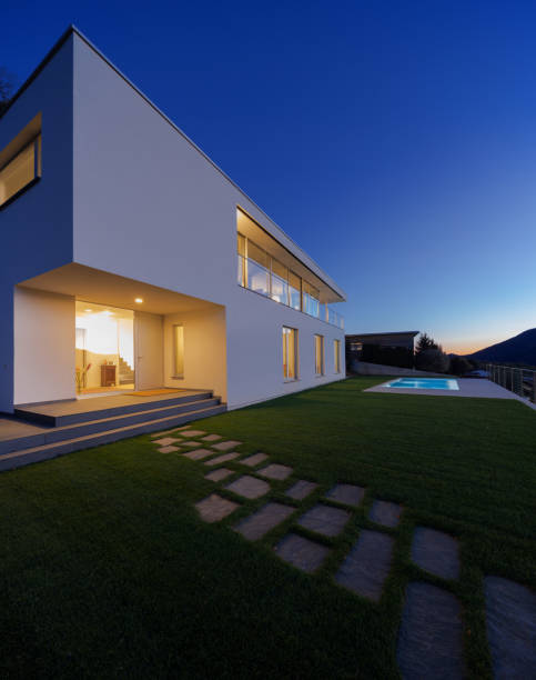 istock Modern villa, exterior in the night, lights on 872979774