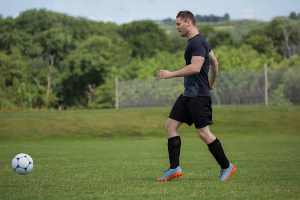 istock Player practicing football in the ground 872980150