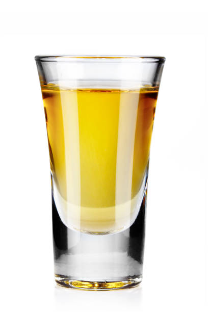 istock Gold tequila shot isolated on white 872980282