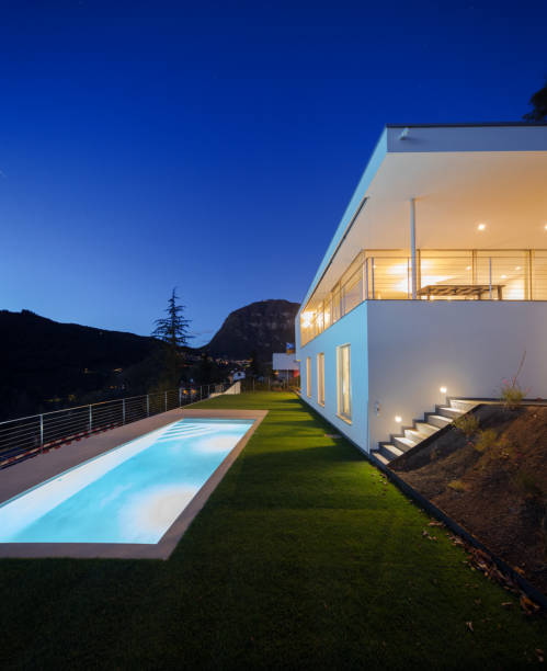 istock Modern villa, exterior in the night, lights on 872983772