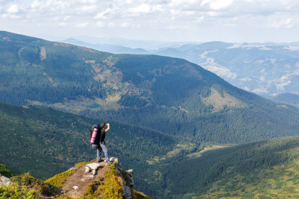 istock Man standing on top of cliff 873003920