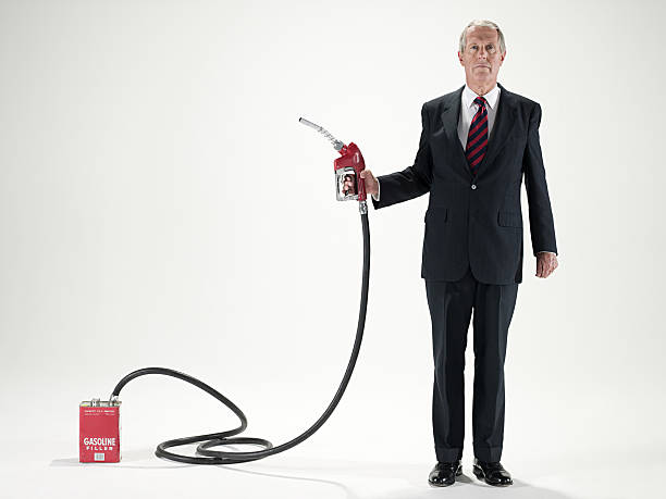 man holding a fuel pump - industrislang bildbanksfoton och bilder