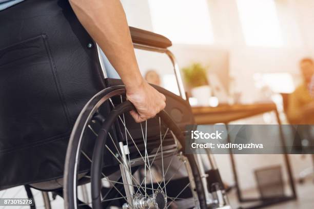 A Disabled Man Is Sitting In A Wheelchair Stock Photo - Download Image Now - Wheelchair, Disability, Working