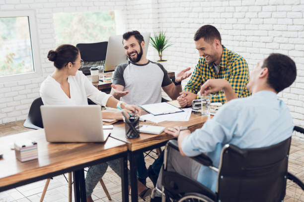 istock A group of young people discussing business while working in the office. 873016022