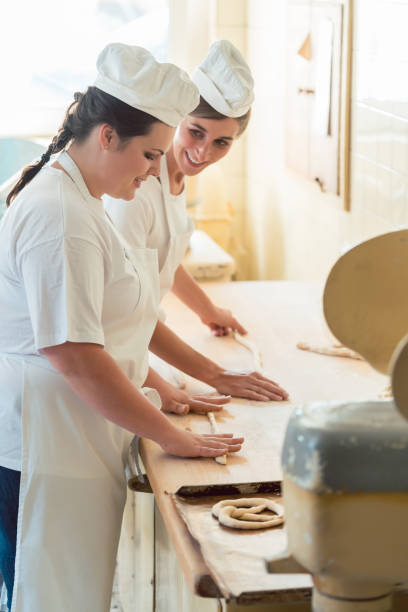 istock Baker women working in bakehouse of bakery 873016448