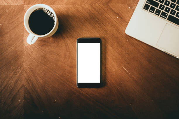 istock Phone On Table From Above With Coffee And Laptop 873019292