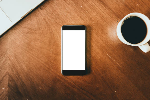 istock Phone From Overhead With Coffee Cup and Laptop 873019294