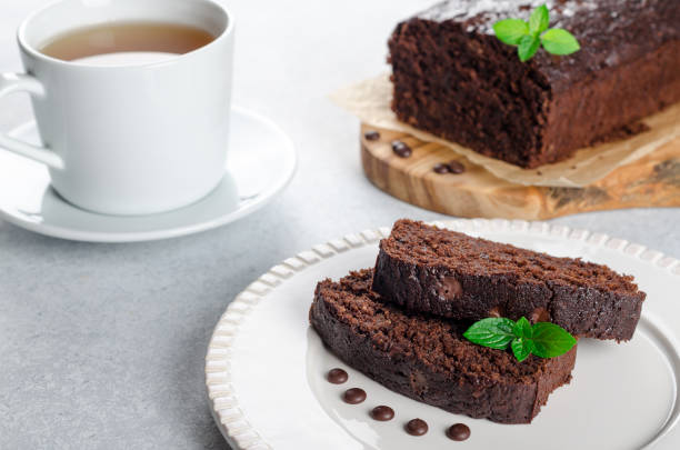 istock Two slices of chocolate cake with mint leaves served on a white 873019604