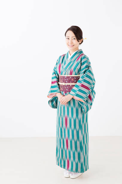 portrait of young asian woman wearing kimono isolated on white background portrait of young asian woman wearing kimono isolated on white background kimono stock pictures, royalty-free photos & images