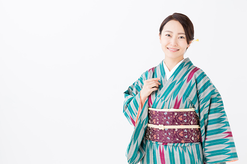 portrait of young asian woman wearing kimono isolated on white background
