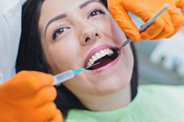 istock Dentist giving patient anesthesia 873025080