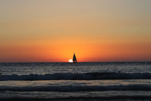 sunset at mediterranean beach - sailboat sunset tel aviv sea imagens e fotografias de stock