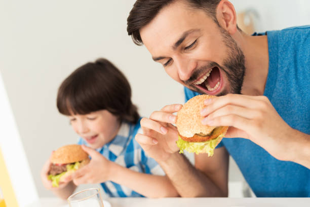 istock Father and son have breakfast in the light kitchen. 873025762