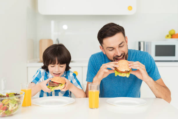 istock Father and son have breakfast in the light kitchen. 873025768