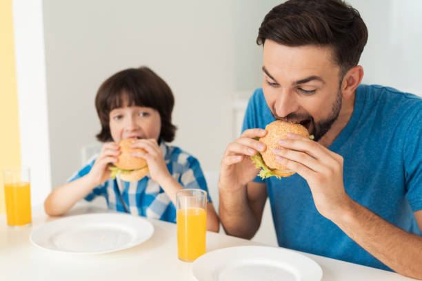 istock Father and son have breakfast in the light kitchen. 873025778