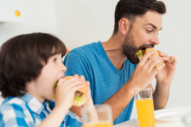 istock Father and son have breakfast in the light kitchen. 873026278