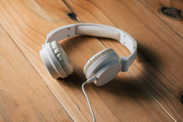 istock White headphones on wooden table 873028272