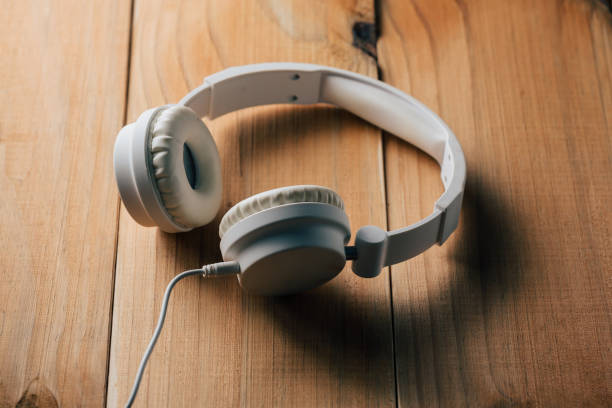 istock White headphones on wooden table 873028626