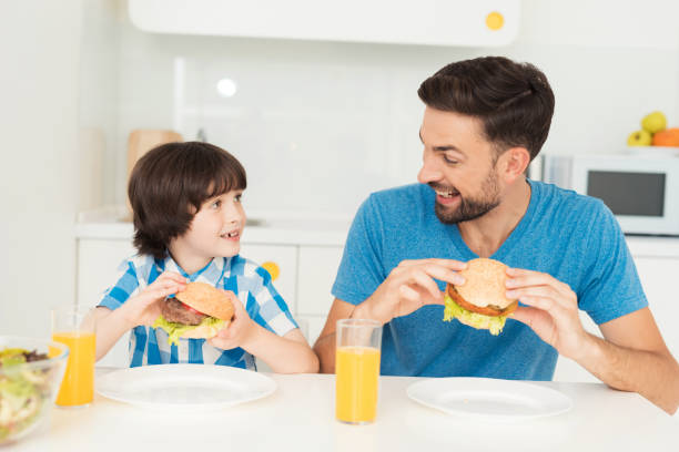istock Father and son have breakfast in the light kitchen. 873028706