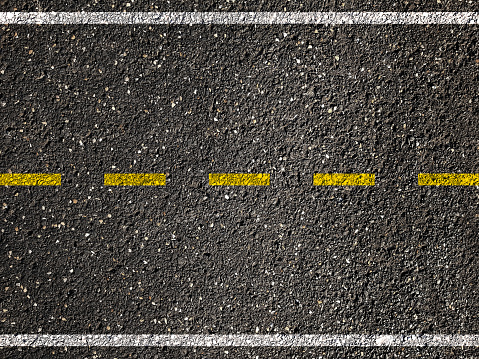 Yellow line on asphalt road background.