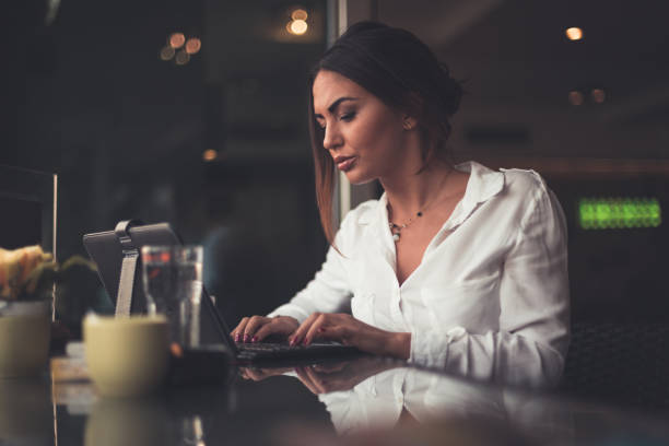 istock Young businesswoman using digital tablet in the coffee bar 873039244