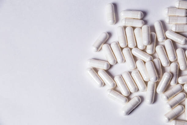 istock sport nutrition, supplements - bcaa in capsules  on the white background 873059470