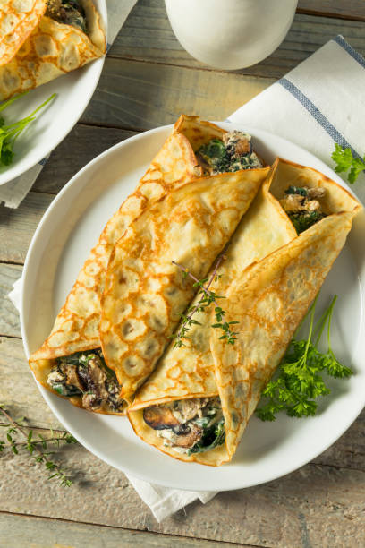 istock Savory Homemade Mushroom and Spinach Crepes 873069502