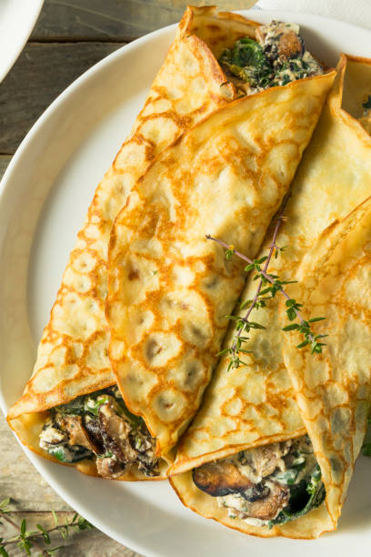 istock Savory Homemade Mushroom and Spinach Crepes 873072288