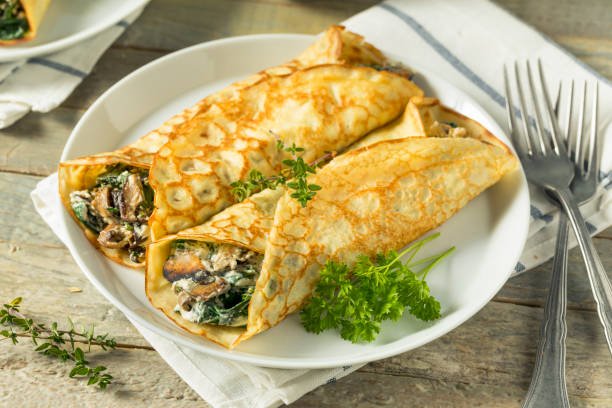 istock Savory Homemade Mushroom and Spinach Crepes 873075262