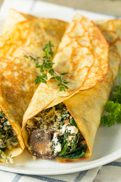 istock Savory Homemade Mushroom and Spinach Crepes 873075368