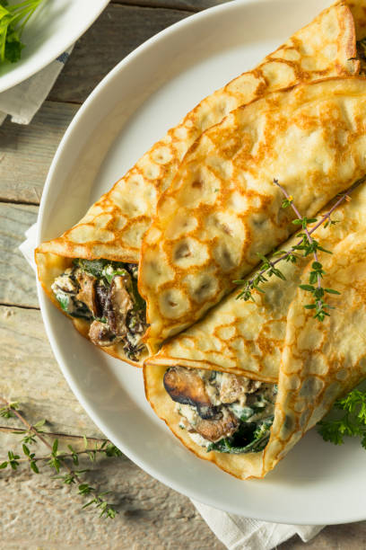 istock Savory Homemade Mushroom and Spinach Crepes 873075492