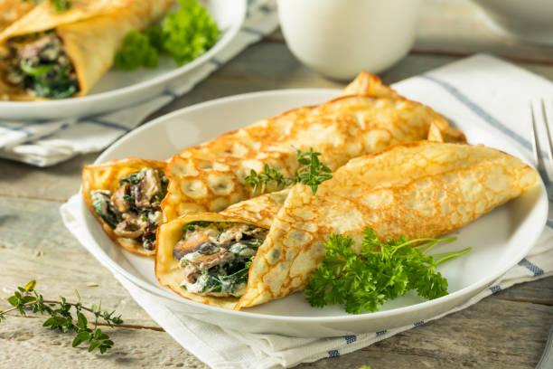 istock Savory Homemade Mushroom and Spinach Crepes 873075606