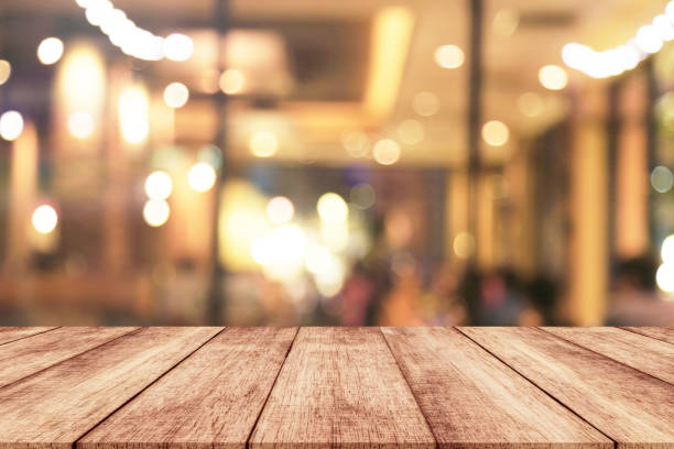istock Wood table with blur light bokeh in night restaurant 873075642