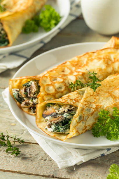 istock Savory Homemade Mushroom and Spinach Crepes 873075662