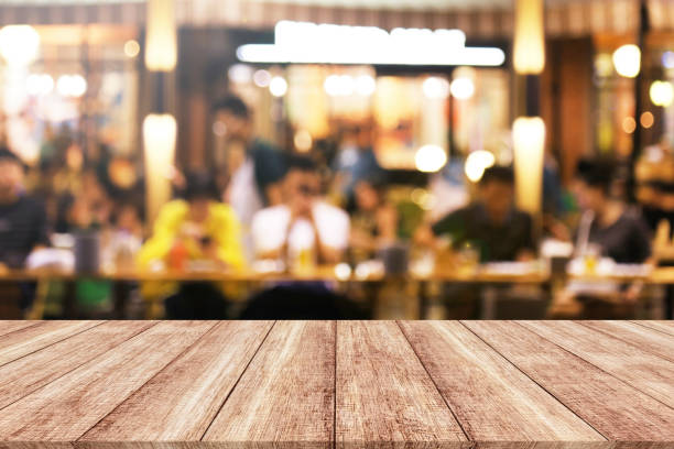 istock Wood table with blur light bokeh in night restaurant 873075672